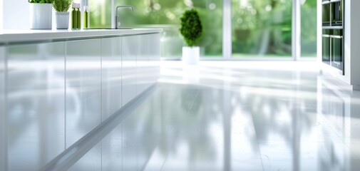 Fototapete - A modern kitchen showcasing sleek cabinets and glossy floors with natural light streaming through large windows, creating a peaceful atmosphere.