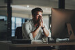 © HockleyM3/peopleimages.com - Night, man and headache at desk for mistake, budget issue and anxiety for economy crash. Male administrator, stress and financial crisis in office with technology, depression and tension with burnout