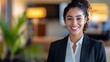 © Pascal - Mixed Race Woman Hotel Receptionist - female, woman, professional, smile, business, brunette, suit, office, indoors, portrait, friendly, confident, young adult, businesswoman