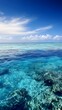 © Nattawee - A panoramic view of a serene reef barrier, with crystal clear water and a bright blue sky in the distance