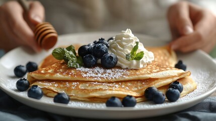 Wall Mural - delicious homemade crepes topped with blueberries, whipped cream, and honey, beautifully presented on a white platter perfect breakfast dish idea