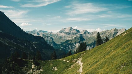 Wall Mural - Mountain range with hiking trail and clear blue sky.