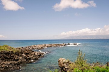 Wall Mural - Scenic coastal view with rocky shores and clear blue waters.