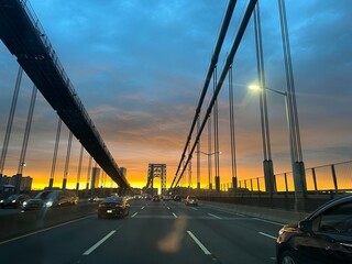 A car ride through NYC bridge during sunset
