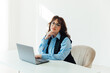 © dmitriisimakov - business woman in glasses working on laptop online training in office