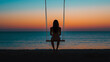 © Jirut - Back view of a single woman alone, gently swinging on a beach swing