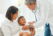 © KayExam/peopleimages.com - Mother, child and doctor with checkup for heart beat, exam or test on health, flu or symptoms at home. Mom, kid or son with cardiologist for consultation, medical care or visit on pulse rate at house
