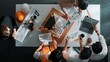 © InfiniteFlow - Top down view of skilled engineer team compare between blueprint and house plan. Aerial view of group of architect or designer discussing and point note to brainstorm about blueprint. Alimentation.