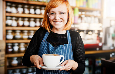 Portrait, happy woman and barista serve coffee in shop for customer service, hospitality and order. Face, smile and waitress giving cup in cafe to offer latte, espresso and drink in small business