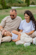 © Tina kids photo - happy family is relaxing on a green lawn in the park in summer