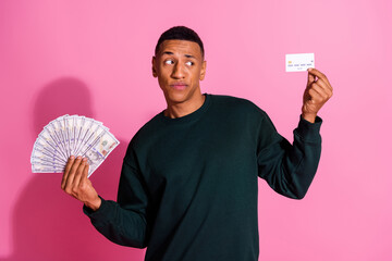 Sticker - Photo of dountful uncertain guy dressed pullover comparing bank card dollars fan emtpy space isolated pink color background