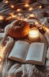 © olegganko - Cozy autumn evening with a pumpkin, candle, and an open book by the window on a warm blanket