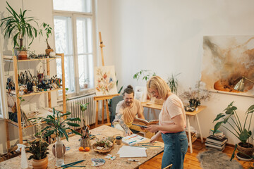 Wall Mural - Creative artist couple creating and chatting at art studio.