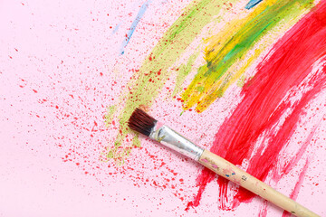 Wall Mural - Artist's brush with paints on pink background, closeup