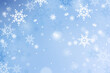 © Desenarrt - Winter sky with fuzzy beautiful snowflakes. Winter background with snow. December serene design