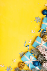 Wall Mural - christmas vertical yellow-blue background with pine tree, gifts