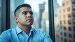© raja - Pensive Man Gazing Out of Window in Cityscape Setting