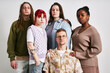© Seventyfour - Portrait of group of five young adults of diverse ethnic backgrounds standing together against neutral background, showcasing various styles and personalities