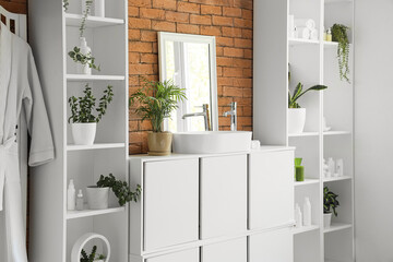 Canvas Print - Interior of stylish bathroom with chest of drawers, sink and shelving unit