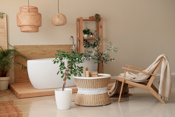 Canvas Print - Interior of comfortable bathroom with coffee table, bathtub, houseplant and armchair