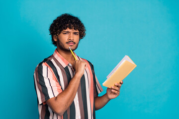 Wall Mural - Photo of nice young man think notepad empty space wear shirt isolated on teal color background