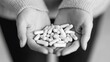 © suyu - Close-up of female hands holding multiple pills, symbolizing medication overdose, addiction, and substance abuse issues, highlighting the serious consequences of drug dependency and health risks