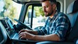 © NATTAWUT - Truckers working on a laptop managing logistics and route planning