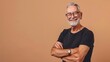 © The Little Hut - Caucasian confident handsome imposing retired senior man 60 years old smiling looking confidently at camera posing with arms folded isolated on beige background Mature people and lifes : Generative AI