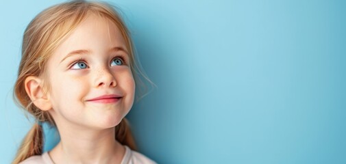 a young girl with blonde hair and blue eyes is looking up at the sky