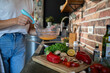 © Geber86 - Woman whisking eggs for healthy meal prep with fresh vegetables in kitchen