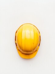 minimalist aerial view of yellow hard hat on roof of unfinished skyscraper