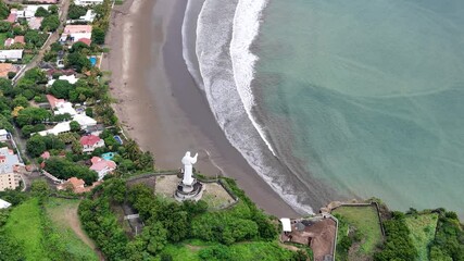 Poster - Jesus christ statue monument on green sea background aerial drone view