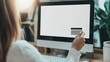 © DREAMERLYN STUDIO - A mockup of a woman holding a credit card in front of a desktop with a blank screen, perfect for illustrating online shopping scenarios