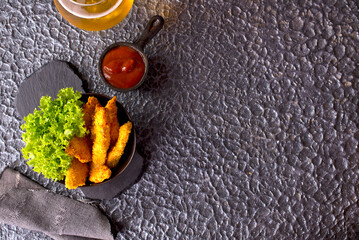 Canvas Print - There is a plate of crispy chicken nuggets on the table.