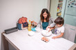 © unai - A woman and a child are making a cake together