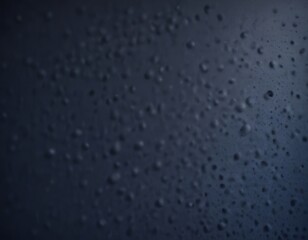 Aufkleber - a close-up view of a dark surface with numerous small, round droplets scattered across it, creating a textured and abstract pattern.