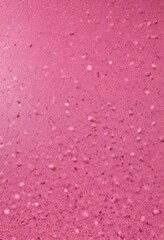 Poster - A close-up view of a pinkish-red surface with small white speckles, resembling a textured or speckled pattern.