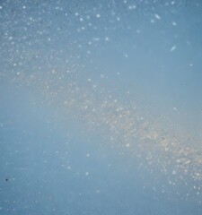Poster - a blurred, abstract representation of a galaxy or starry night sky, with a gradient of blue tones and small white specks or particles scattered throughout.