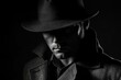 © Yeivaz - Mysterious Detective in Shadowy Silhouette wears a Fedora Hat and Trench Coat on black background