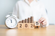 © Jo Panuwat D - 2024 end year to Happy New Year 2025 with clock and coins stack arrangement. Money Saving for Future Plan, Retirement fund, Pension, Investment, Wealth Business, Financial and countdown concepts
