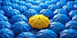 © Fist - a collection of blue umbrellas with a single yellow umbrella
