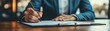 © BonzEarthsnapper - Businessperson making notes on a document while negotiating with a client, business deal, preparing for agreement