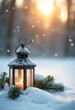 © Giuseppe Cammino - In the sunlight, a Christmas lantern rests on snow with a branch of fir. Winter decoration background, copy space on a side
