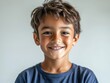© M2A - Bright Smiling Young Boy in Casual Blue T-Shirt with Radiant Expression, Capturing the Joy and Energy of Childhood in a Natural, Minimalist Setting – Perfect for Themes of Happiness, Youth, and Innoce