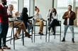 © Jacob Lund - Diverse group of professionals talking and engaging in a business conference event