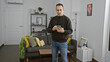 © Krakenimages.com - A man holding smartphone intently browses in a modern home interior with tasteful decor and furniture.