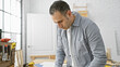 © Krakenimages.com - Handsome hispanic man concentrating on a task in a bright carpentry workshop.