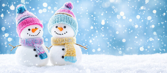 Festive Snowmen in Bright Hats and Scarves Enjoying the Winter. A playful pair of snowmen, bundled up in colorful winter attire, having fun together in a snow-covered setting with a calm winter vibe.
