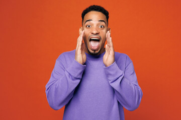 Poster - Young man of African American ethnicity wear purple sweatshirt casual clothes scream sharing hot news about sales discount, hands near mouth isolated on plain red orange background. Lifestyle concept.