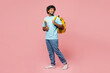 © ViDi Studio - Full body side view happy young Indian boy student wear blue t-shirt casual clothes backpack bag hold books look aside on area isolated on plain pink background High school university college concept